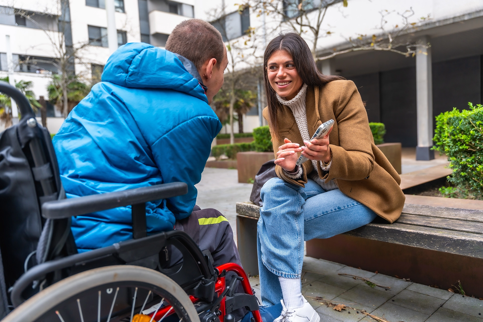 A support worker talking with a person in a wheelchair